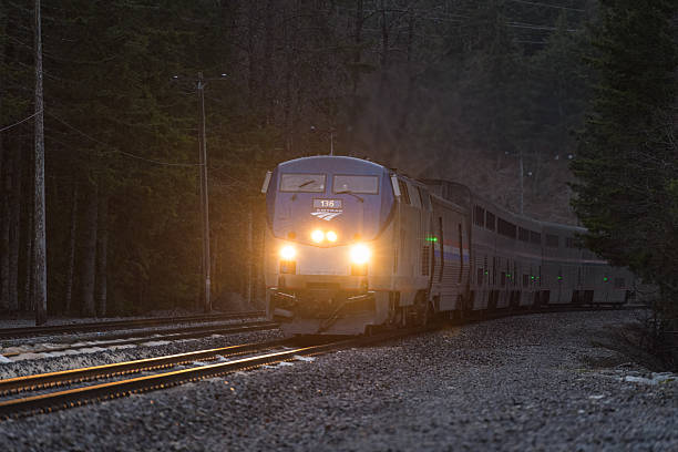 Scenic, WA, USA - April 9, 2019; Amtraks Empire Builder approaches the Cascade Tunnel as night falls on the Seattle to Chicago sleeper train