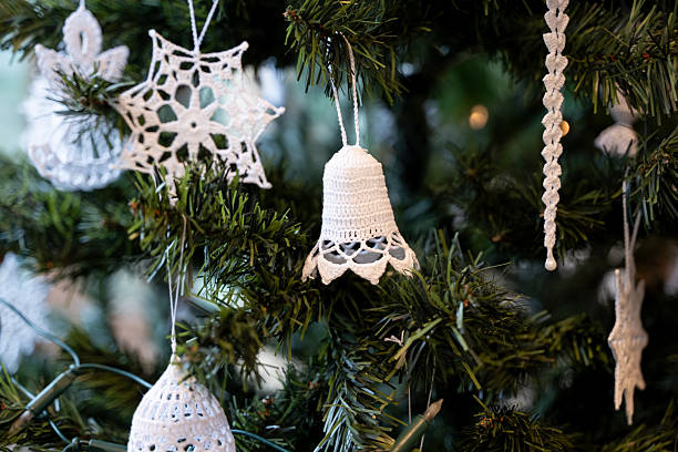 Christmas bell toy and branch of christmas tree on a burlap background