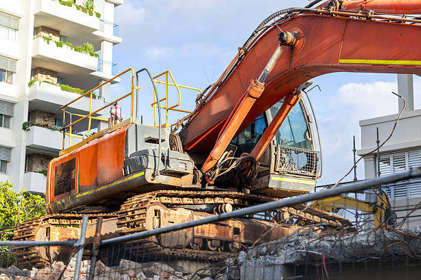 Closeup Excavator at demolition site, background with copy space, full frame horizontal composition