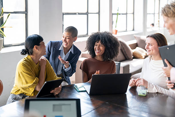 istock Cheerful businesswomen collaborating on project in modern office 2254671924