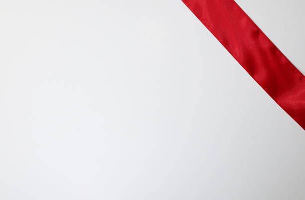 Red ribbon on white background with copy space for text or image.
