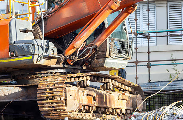 Closeup Excavator at demolition site, side view, background with copy space, full frame horizontal composition