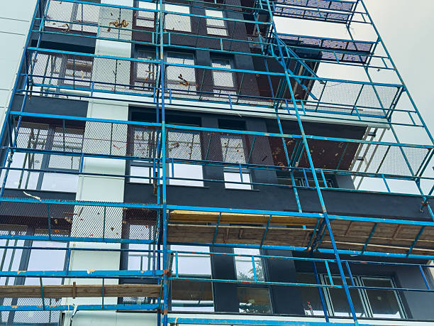 istock Construction work on a tall building with scaffolding and workers on site in the city during the day 2254679677