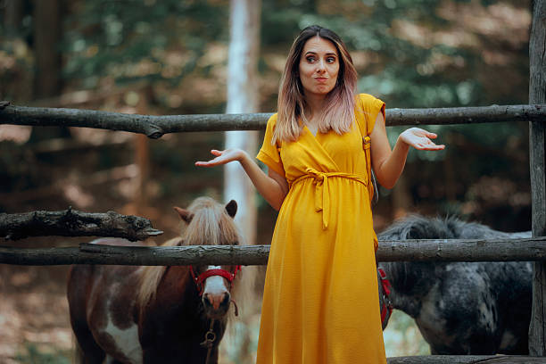 istock Indecisive Woman Visits Pony Park on Summer Vacation 2254683635