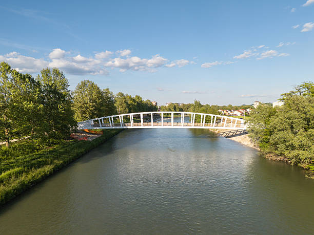 istock Modern pedestrian bridge over a calm river 2254684382