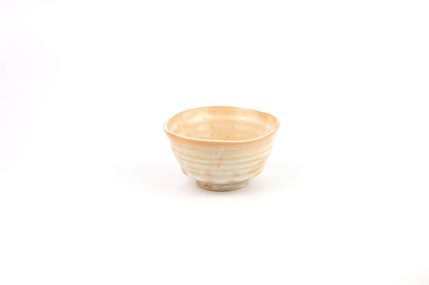 istock An elegant handmade ceramic bowl with a rustic texture and natural cream glaze, featuring concentric rings from the pottery wheel. Japanese Chawan style is perfectly isolated on white background. 2254687850