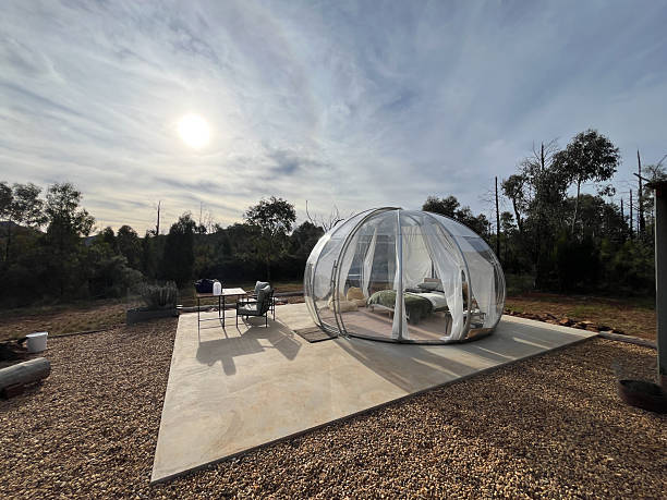 istock A transparent bubble hotel sits in the sun, offering a unique glamping accommodation experience 2254692713