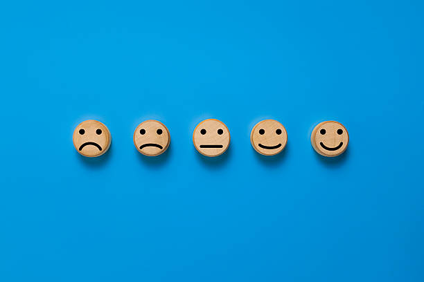 istock blocks with five different emoji expression from sad to happy. isolated on blue background. rating scale satisfaction feedback concept 2254697851
