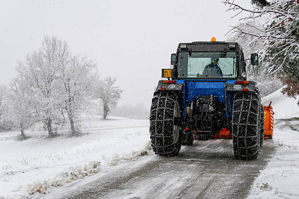 snow plow working in winter landscape in Austria