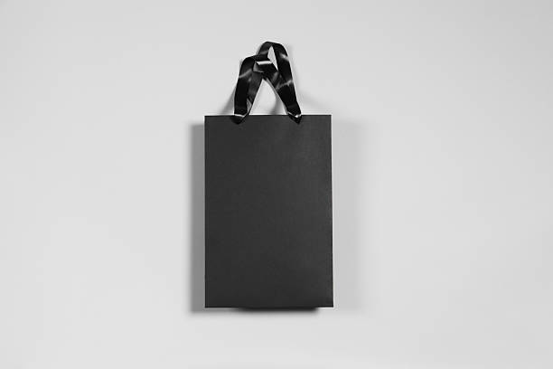 istock One black paper shopping bag on grey background, top view 2254707742