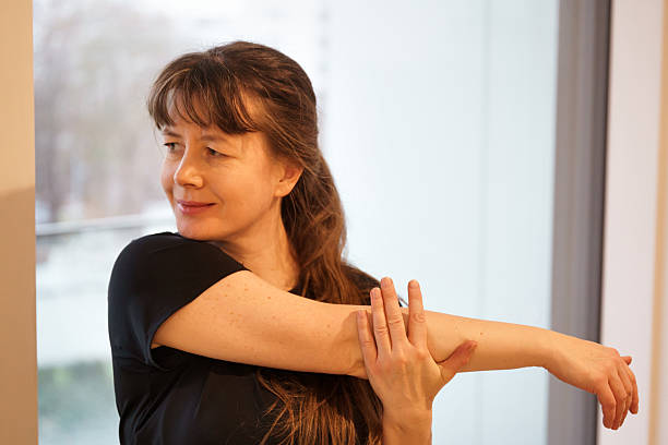 istock Woman stretching arm near window 2254709712