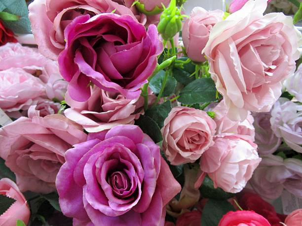 delicate bouquet of white, cream roses, purple roses and other flowers