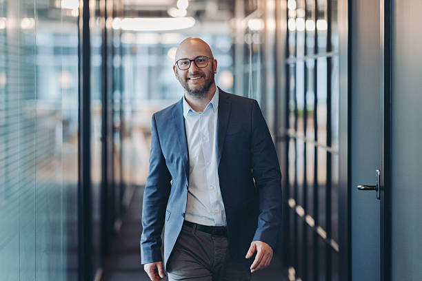 istock Confident businessman walking in the office 2254711029