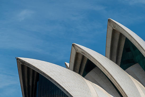 The top structures and roof tiles of some of the sails of the Sydney Opera House on Sydney Harbour.  This image was taken from a passing public transport ferry on a hot and sunny afternoon on 5 January 2026.