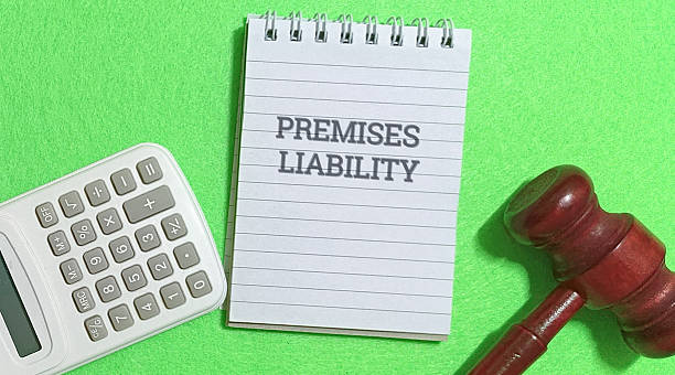 istock Premises liability concept with gavel and calculator on green background 2254711489