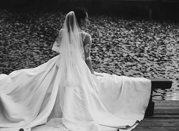 Young beautiful bride outdoors near lake.