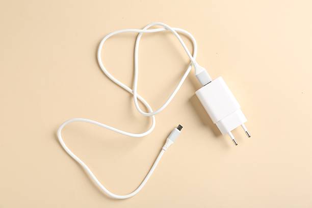 istock USB power adapter with charge cable on beige background, top view 2254711864