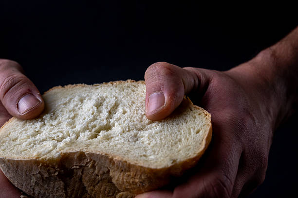 istock Hands Holding A Simple Slice Of Bread 2254713488