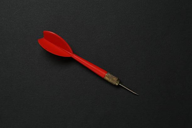 One red dart arrow on black background, top view