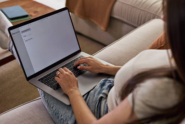 istock Person Working On Laptop At Home On Couch In Casual, Comfortable Home Office Setting 2254716741