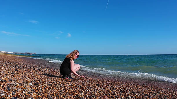 A woman observes expansive calm ocean view