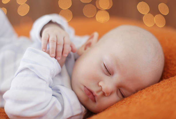 Peaceful baby lying on a bed while sleeping