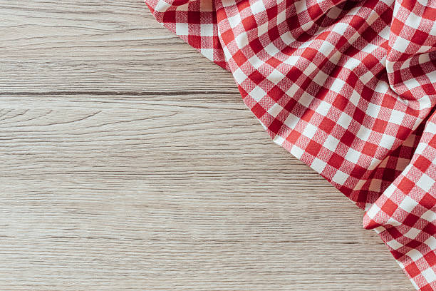 istock Red and White Checkered Table Cloth on Light Wooden Surface 2254719807
