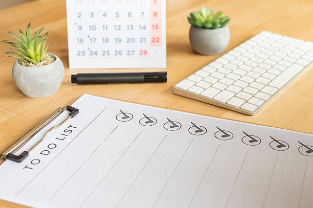 istock To do list on a clipboard showing multiple tasks completed with check marks, alongside a calendar, keyboard, marker, and two small succulent plants on a wooden desk 2254720978