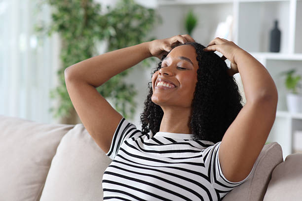 istock Happy black woman self massaging head with her hands 2254724732