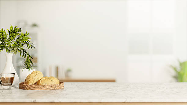istock Bread plate and coffee cup with white vase on marble counter table across window wall in living room 2254724850