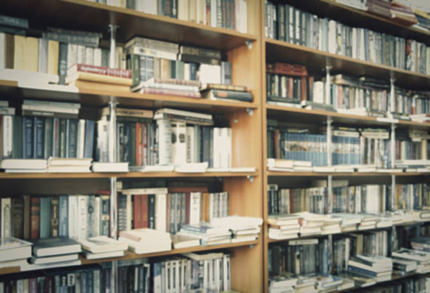 blurred bookshelf in library for your background design