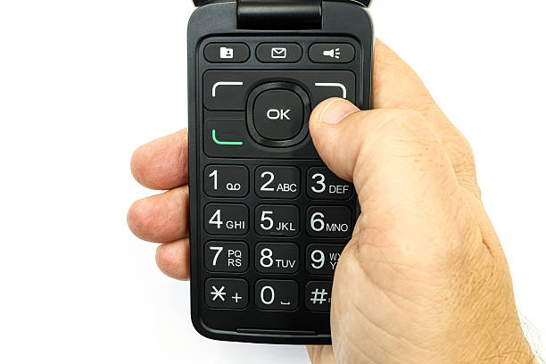 Old used cell phone on dark background