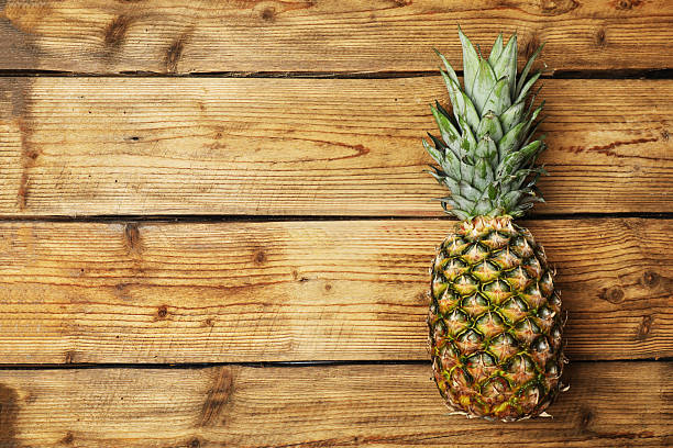 Citrus fruits and pineapple on table with space for text