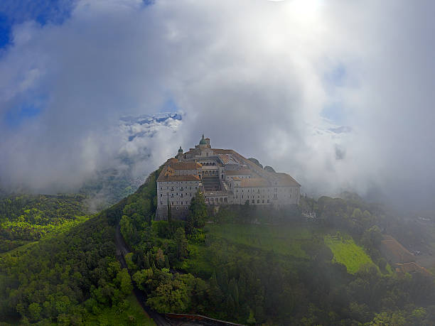 Monte Cassino monastery in the morning mist. Monte Cassino Abbey, the first monastery of the Benedictine order, located to the south of Rome, at the top of Mount Cassino, Italy