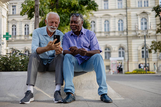 istock Two Old Men Looking at Phone Together – Technology Meets Friendship 2254730936