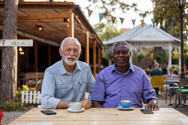 istock Elderly men relaxing with coffee outdoors looking at camera 2254730953