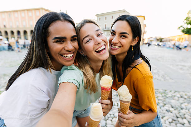 istock Three female friends eating ice cream while taking selfie during summer vacation 2254731462