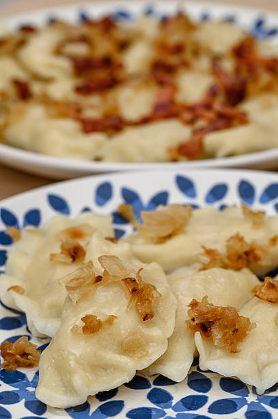 Hot boiled dumplings with crispy fried bacon filling on plates