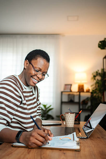 istock Happy woman working on documents in home office 2254733422