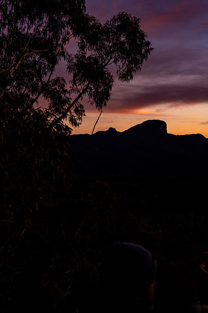 The fiery hues of sunset washing over the rugged peaks.