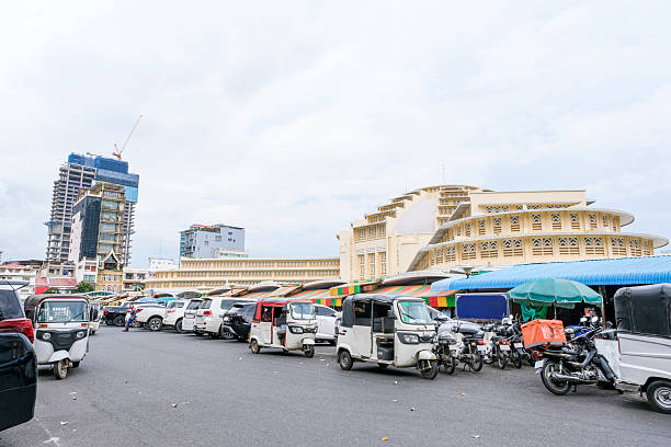unidentified local people sit on the motor waiting someone. Phnom Penh is the capital of cambodia.