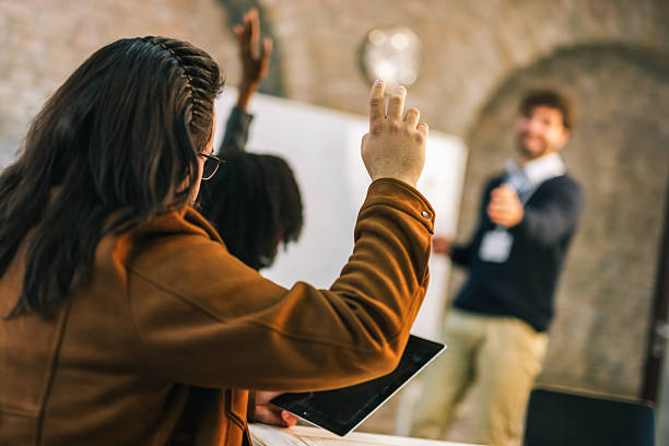 istock Team member raises hand during business meeting 2254738016