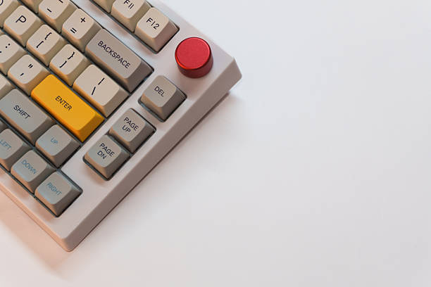 istock White mechanical keyboard with bright Enter key on white background, minimalism, keyboard buttons. A keyboard with a yellow key 2254738381