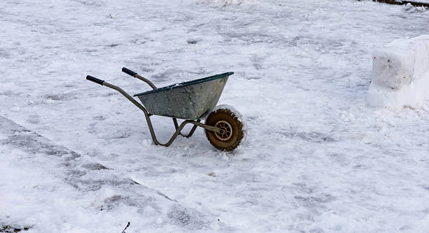 Wheelbarrow standing in the snow.