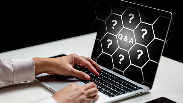 istock Person uses a laptop with a question and answer graphic displayed on the screen. Concept of Questions and Answers 2254739099