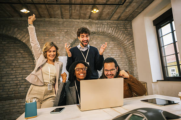 istock Diverse business team celebrating success at laptop 2254740603