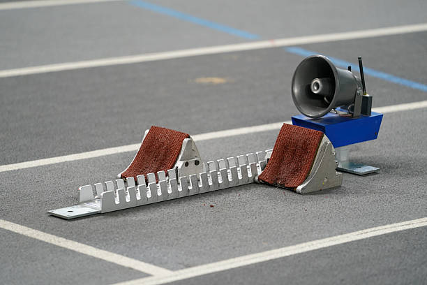 Beautiful blonde athletics mother running coach during a training session on the running track