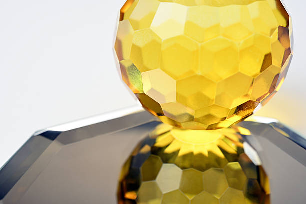 The pattern of Square mirror tiles with Shining golden lighting reflected in them. Texture mirrored tiles background, use it as your Wallpaper, Poster and Copy space, Selective focus.