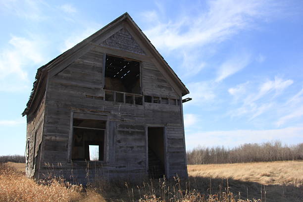 An abandoned farm house in rural Prince Edward Island.  Full Moon behind the house with light painting both inside & out.  Slight grain in sky.