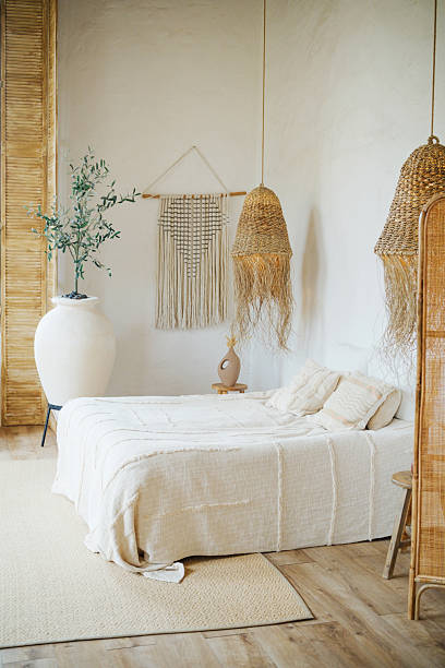 istock Natural bedroom interior with white bedding and hanging straw lamps 2254751356